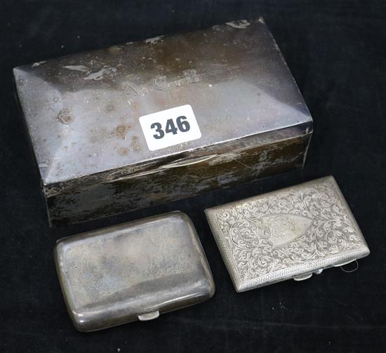 A silver cigarette box and two silver cigarette cases